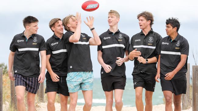 POWER SIX-PACK: Port Adelaide recruits, from left, Dylan Williams, Jackson Mead, Miles Bergman, Jake Pasini, Mitch Georgiades and Trent Burgoyne get acquainted at Grange beach yesterday. Picture: RUSSELL MILLARD (AAP).