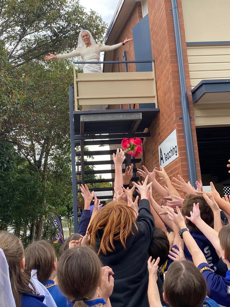 Miss Irwin throws her bouquet to her eager Year 6 class.