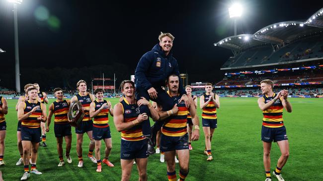 Rory Sloane chaired off by Matt Crouch and Taylor Walker after their win during last year’s AFL Round 8 Showdown at Adelaide Oval. Picture: James Elsby/AFL photos via Getty Images