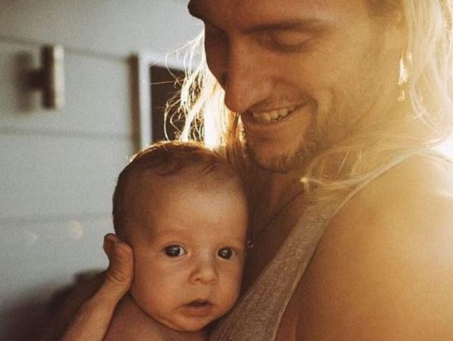 Surfer Owen Wright with his son Vali. Pic: Corey Wilson.