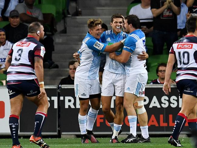 Matt Duffie of the Blues (centre) celebrates after scoring a try during the round 1 Super Rugby match between the Melbourne Rebels and the Blues at AAMI Park in Melbourne, Thursday, Feb. 23, 2017. (AAP Image/Tracey Nearmy) NO ARCHIVING, EDITORIAL USE ONLY