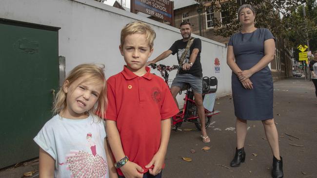 Jenny Leong with resident Dylan Regtop and his children, Olive, 4, and Dexter, 7, outside the school ON Cleveland St, Redfern. Picture: Quentin Jones