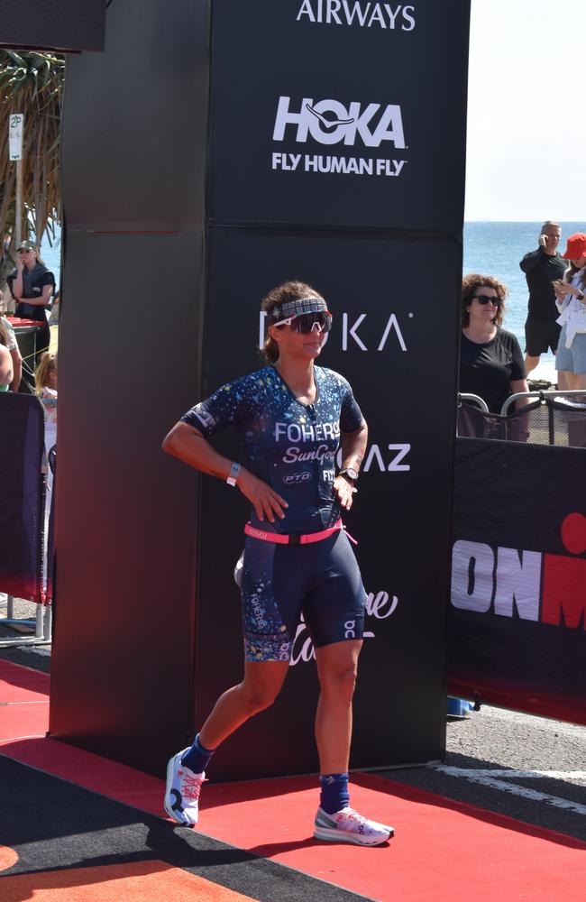 Athletes crossing the finish line at the Sunshine Coast Ironman 70.3 2023.