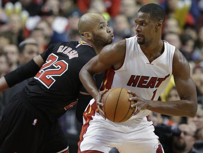 Miami’s Chris Bosh drives against Chicago’s Taj Gibson.