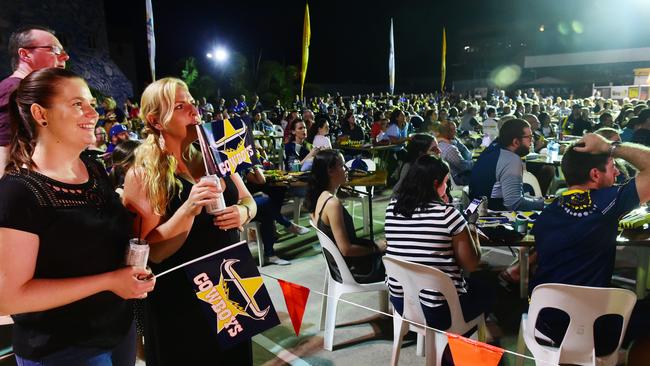 Cowboys fans packed the carpark behind the Cowboys Leagues club to watch their team smash the Sydney Roosters (L) Megan Finch of Alice River and Kristy Ralph of Gold Coast watch on.