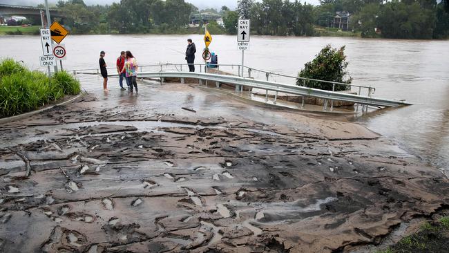 Local residents inspected mud that cakes the road leading down to the boat ramp after the waters receded in 2021. Picture: Toby Zerna