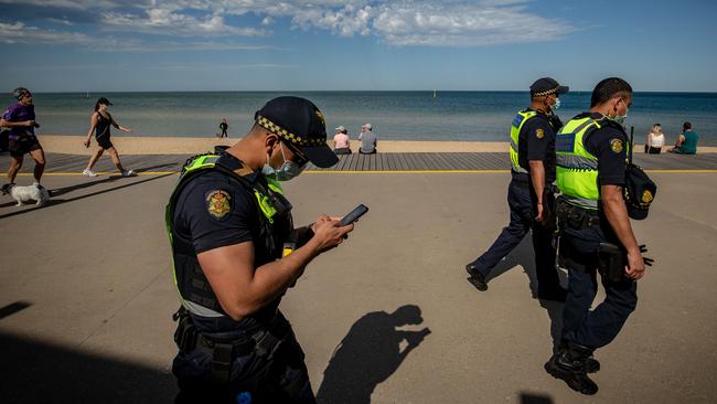 Public Service Officers patrol St Kilda beach.