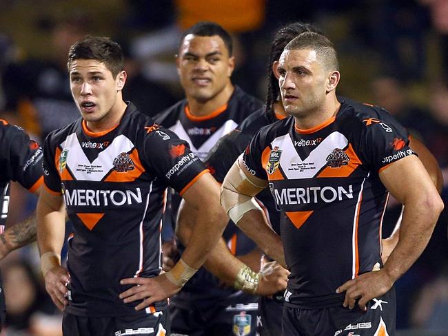 SYDNEY, AUSTRALIA - AUGUST 04: Dejected Tigers players watch as Cameron Smith converts a try during the round 21 NRL match between the Wests Tigers and the Melbourne Storm at Campbelltown Sports Stadium on August 4, 2014 in Sydney, Australia. (Photo by Renee McKay/Getty Images)