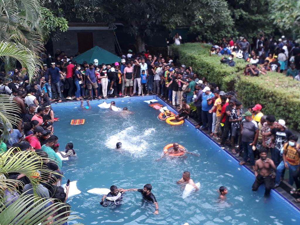 Protesters swim in a pool inside the compound of Sri Lanka's Presidential Palace in Colombo. Picture: AFP