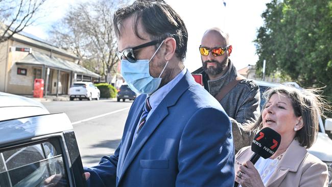 Former teacher Matthew Corey Schulz, centre, outside court. Picture: Brenton Edwards