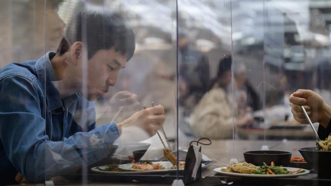 Employees eat in a cafeteria at the offices of Hyundai Card credit card company in Seoul. Picture: Ed Jones/AFP