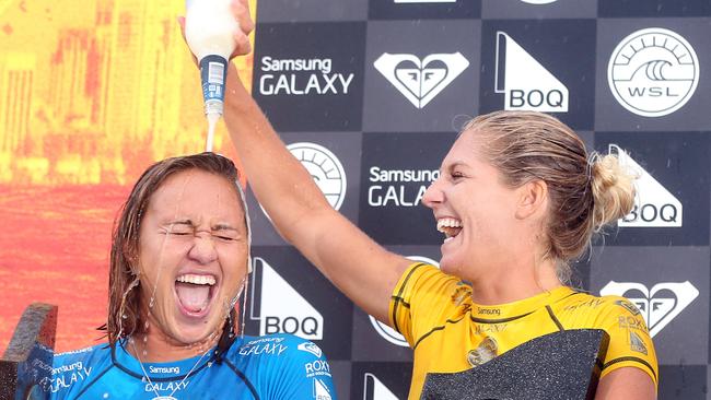 Roxy Pro winner Carissa Moore is drenched by runner-up Steph Gilmore after the trophy presentation at Snapper Rocks. Photo: Richard Gosling