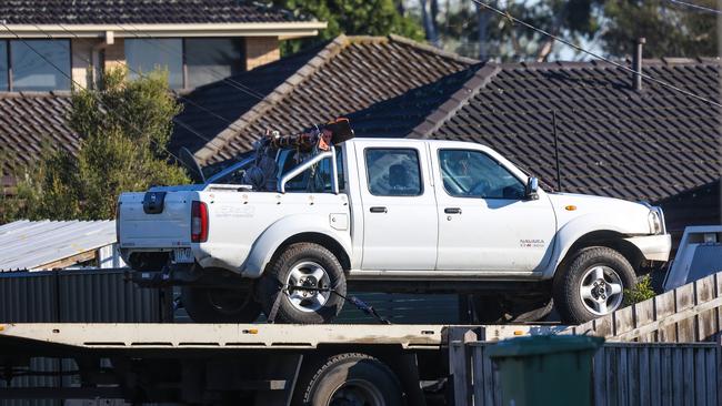A ute is towed from the house involved in the shooting. Picture: Ian Currie