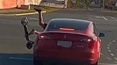 An e-scooter rider is thrown off his ride after smashing into a Tesla. Picture: Dash Cam Owners Australia