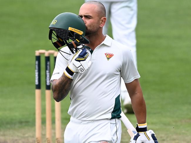 HOBART, AUSTRALIA - MARCH 17: Jake Weatherald of Tasmania kisses his helmet after scoring a century during the Sheffield Shield match between Tasmania and New South Wales at Blundstone Arena, on March 17, 2025, in Hobart, Australia. (Photo by Steve Bell/Getty Images)