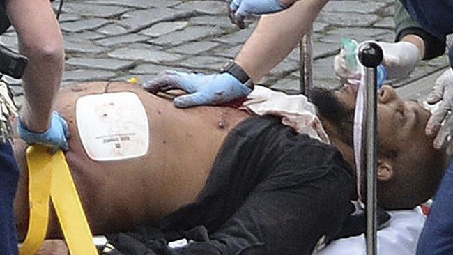 Khalid Masood is treated by emergency services outside the Houses of Parliament London. Picture: Stefan Rousseau/PA via AP, File.