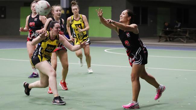 Saints' Moera Blair shifts the ball down the court with a smile on her face in the Cairns Netball match between North Cairns Tigers and Cairns Saints. PICTURE: BRENDAN RADKE