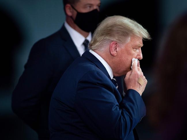 US President Donald Trump wipes his face during a break in an NBC News town hall event in Miami. Picture: AFP