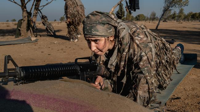 A Kurdish female fighter sharpens her weapon skills in a remote training camp. Picture: Getty Images.