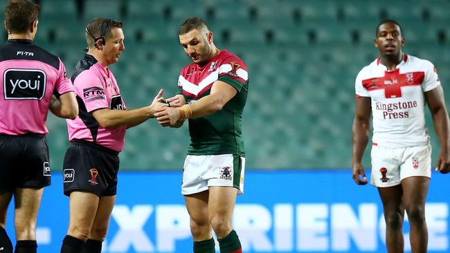 Robbie Farah of Lebanon makes an official complaint of biting against Jermaine McGillvary.