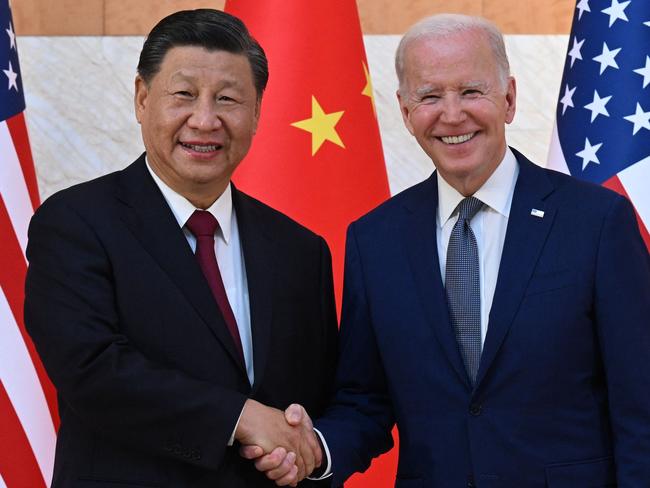 US President Joe Biden (R) and China's President Xi Jinping (L) shake hands as they meet on the sidelines of the G20 Summit in Nusa Dua on the Indonesian resort island of Bali on November 14, 2022. (Photo by SAUL LOEB / AFP)