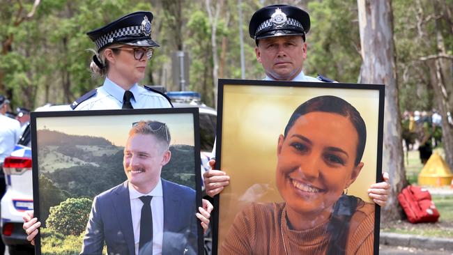 Police officers hold portraits of Constable Matthew Arnold and Constable Rachel McCrow, who were killed at Wieambilla. Picture: Steve Pohlner