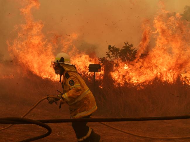 HILLVILLE, AUSTRALIA - NOVEMBER 13: RFS Firefighters battle a spot fire on November 13, 2019 in Hillville, Australia. Catastrophic fire conditions - the highest possible level of bushfire danger - have eased across greater Sydney, Illawarra and Hunter areas thanks to a slight cool change, however dozens of bushfires are still burning. A state of emergency, as declared by NSW Premier Gladys Berejiklian on Monday, is still in effect, giving emergency powers to Rural Fire Service Commissioner Shane Fitzsimmons and prohibiting fires across the state. (Photo by Sam Mooy/Getty Images)