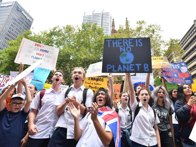 Thousands of school students from across Sydney attend the global #ClimateStrike rally at Town Hall in Sydney, Friday, March 15, 2019. Hundreds of thousands of students are expected to strike worldwide demanding urgent political action on climate change. (AAP Image/Mick Tsikas) NO ARCHIVING