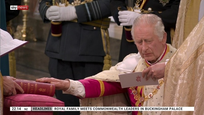 King Charles lays his hands on the bible during the ceremony. Picture: Sky News