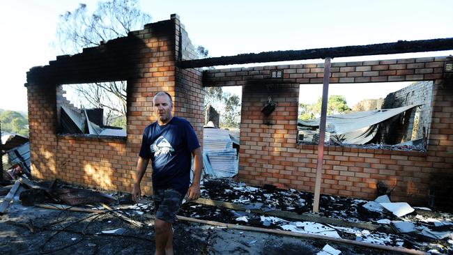 Mr Dowdle, 49, at the destroyed home. Picture: Gary Ramage