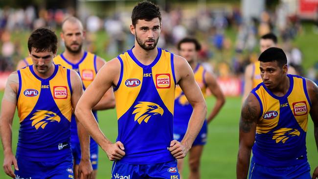 Jarrod Brander, centre, walks off the field after the loss to the Dockers. Picture: Daniel Carson/AFL Photos