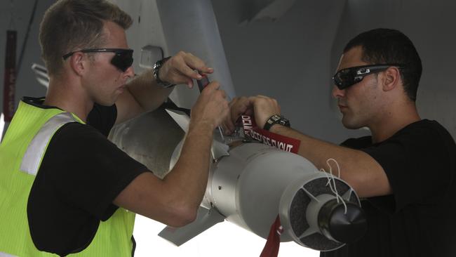 Royal Australian Air Force (RAAF) Armament Technicians, Leading Aircraftmen Brad Burrows (left) and Josh Lees prepare explosive ordnance under the wing of a RAAF F/A-18F Super Hornet in the Middle East. *** Local Caption *** Royal Australian Air Force KC-30A Multi Role Tanker Transport (MRTT) refuelling aircraft continued to support Coalition aircraft over Iraq on Friday, October 03, 2014. During its mission it distributed thousands of litres of fuel to Australian F/A-18F Super Hornets and French Dassault Rafale fighter jets. Six RAAF F/A-18F Super Hornet, an E-7A Wedgetail Early Warning and Control aircraft and a KC-30A Multi-Role Tanker Transport aircraft are assigned to the Air Task Group (ATG). The ATG is supported by 400 RAAF personnel who have deployed to the Middle East since the Australian Government's announcement. Australia’s efforts are in response to a request for assistance by the Iraqi Government in combating ISIL terrorists.