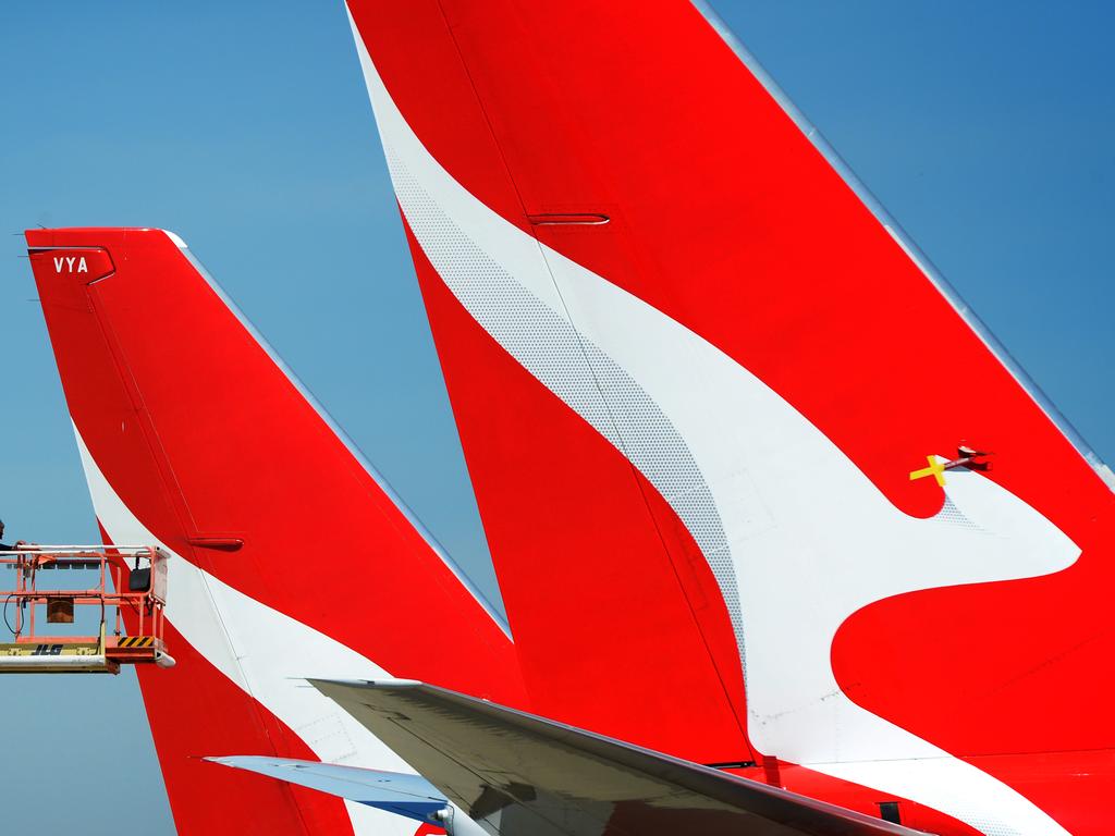 MELBOURNE, AUSTRALIA - NewsWire Photos NOVEMBER 22, 2021: A maintenance worker inspects the tails of QANTAS planes parked at Melbourne Airport. Picture: NCA NewsWire / Andrew Henshaw