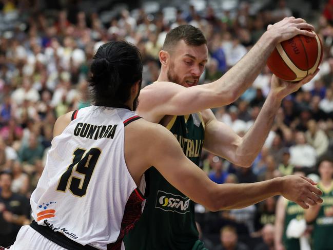 Nick Kay and Muhammad Guntara contest the ball. Picture: Getty Images