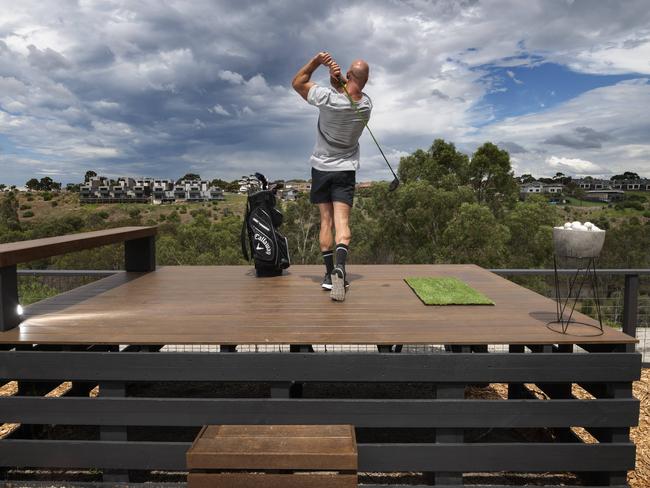 Jackson Barling at his Avondale Heights home, where he's created his own private driving range overlooking the Maribyrnong River. He has listed the house with a $940,000 - $1m price guide. Picture: Tony Gough