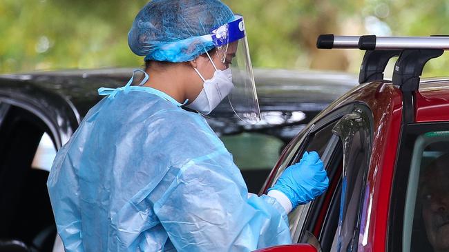 SYDNEY, AUSTRALIA - NewsWire Photos, DECEMBER 20 2021: People are seen lining up to get a Covid-19 test at the Burwood Covid Testing clinic in Sydney ahead of Christmas as positive cases continue to rise in NSW. Picture: NCA Newswire / Gaye Gerard