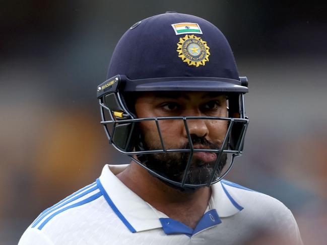 Indiaâs captain Rohit Sharma reacts as he walks off the ground due to bad light on day three of the third cricket Test match between Australia and India at The Gabba in Brisbane on December 16, 2024. (Photo by DAVID GRAY / AFP) / -- IMAGE RESTRICTED TO EDITORIAL USE - STRICTLY NO COMMERCIAL USE --