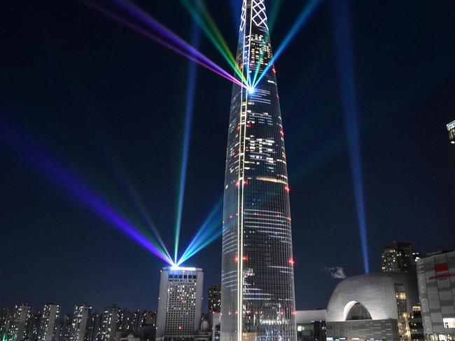 Light beams are projected from the 123-storey Lotte World Tower skyscraper during a countdown lighting show to celebrate the New Year in Seoul on January 1, 2022. Picture: Jung Yeon-je / AFP.