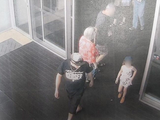 A screen shot of the CCTV of Sterling Free leaving the shopping centre with the little girl .