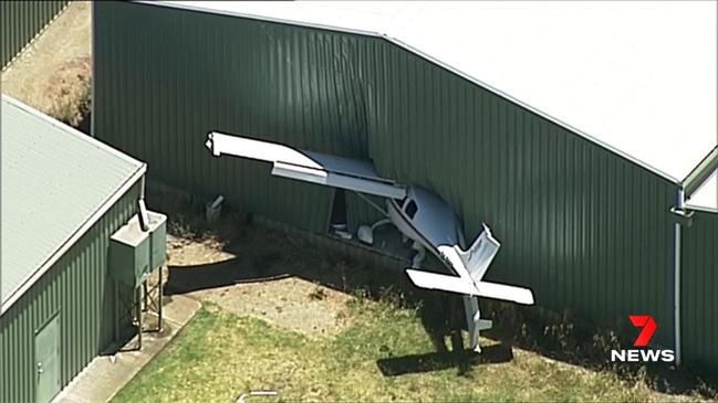 A light plane has slammed through the wall of a hangar at Goolwa Airport. Two men on board have suffered injuries. Picture: 7NEWS