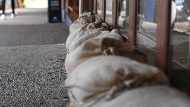 Sandbags are used to protect doors before storms.