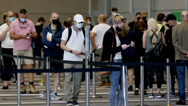 People line up at the mass vaccination hub in Brisbane, where 53.8 per cent of people have had one dose of a Covid-19 vaccine. Picture: Tara Croser.