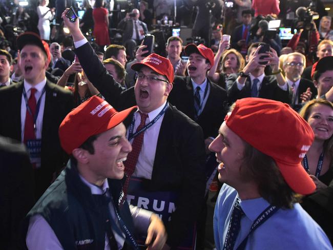 Supporters of Republican presidential nominee Donald Trump react to early poll results during election night at the New York Hilton Midtown in New York on November 8, 2016. / AFP PHOTO / Mandel NGAN