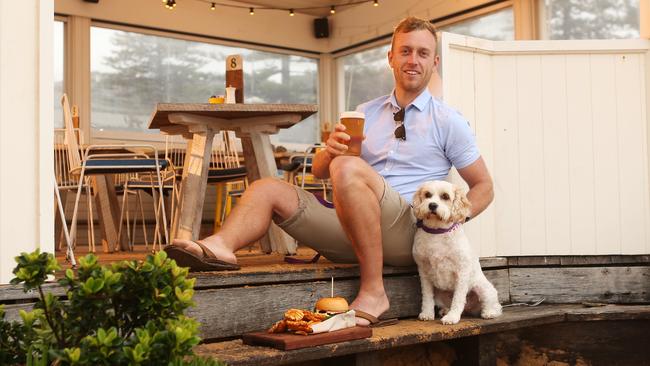 Duncan Stedman and his dog, Tilly, have a drink and something to eat at The Collaroy Hotel’s Pelican Pavilion. Picture: Rohan Kelly