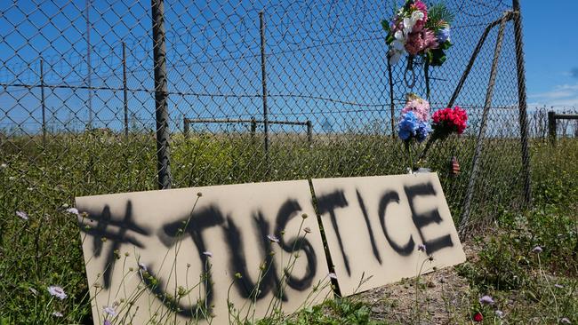 A sign and floral tributes placed at the site of the fatal crash. Picture: Jessica Ball.