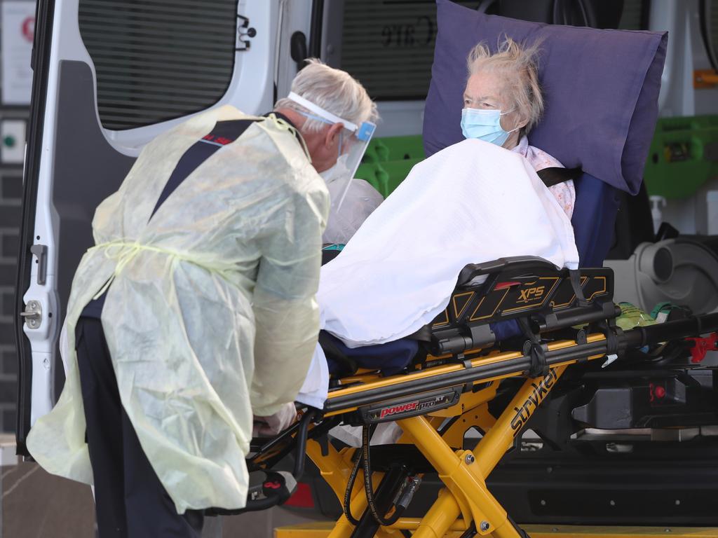 A resident from a virus-stricken Victorian aged care home is transported to hospital. Picture: NCA NewsWire /David Crosling