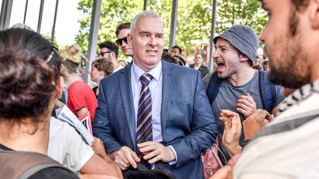 Climate Change protesters jeer a mining executive outside the Melbourne Exhibition Centre hosting the International Mining and Resources Conference. Picture: Jake Nowakowski