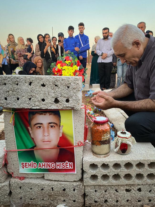 Family pray at the graves of Turkish drone strike victims Ahmad, 16, and Ahing Hussein, 14. Picture: Ellen Whinnett