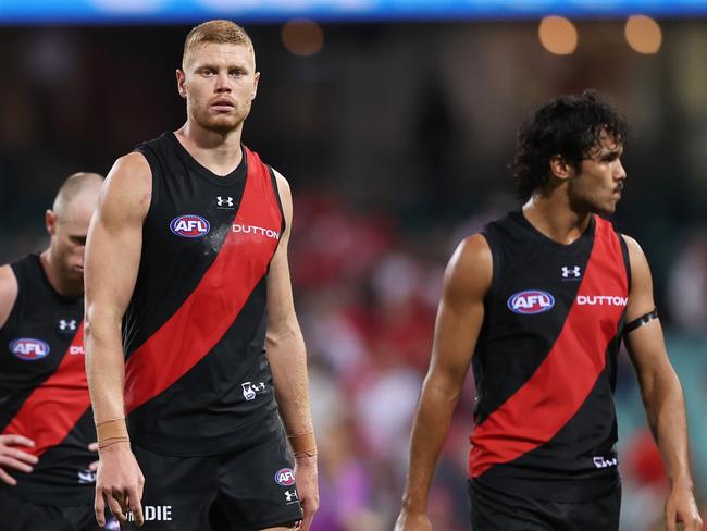 SYDNEY, AUSTRALIA - MARCH 23:  Peter Wright of the Bombers and team mates look dejected after the round two AFL match between Sydney Swans and Essendon Bombers at SCG, on March 23, 2024, in Sydney, Australia. (Photo by Matt King/AFL Photos/via Getty Images )