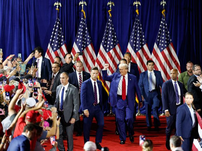 TOPSHOT - Former US President and Republican presidential candidate Donald Trump raises a fist as he arrives to speak at a town hall meeting at La Crosse Center in La Crosse, Wisconsin, on August 29, 2024. (Photo by KAMIL KRZACZYNSKI / AFP)